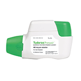 An inhaler device with a white body and green mouthpiece. The label reads "Tudorza Pressair" indicating it's for asthma or COPD treatment, with a dosage of 400 mcg. The inhaler is positioned with the mouthpiece facing left.