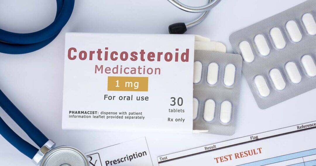 A box labeled "Corticosteroid Medication 1 mg For oral use" sits on a table with tablets, a stethoscope, prescription papers, and a document marked "TEST RESULT.