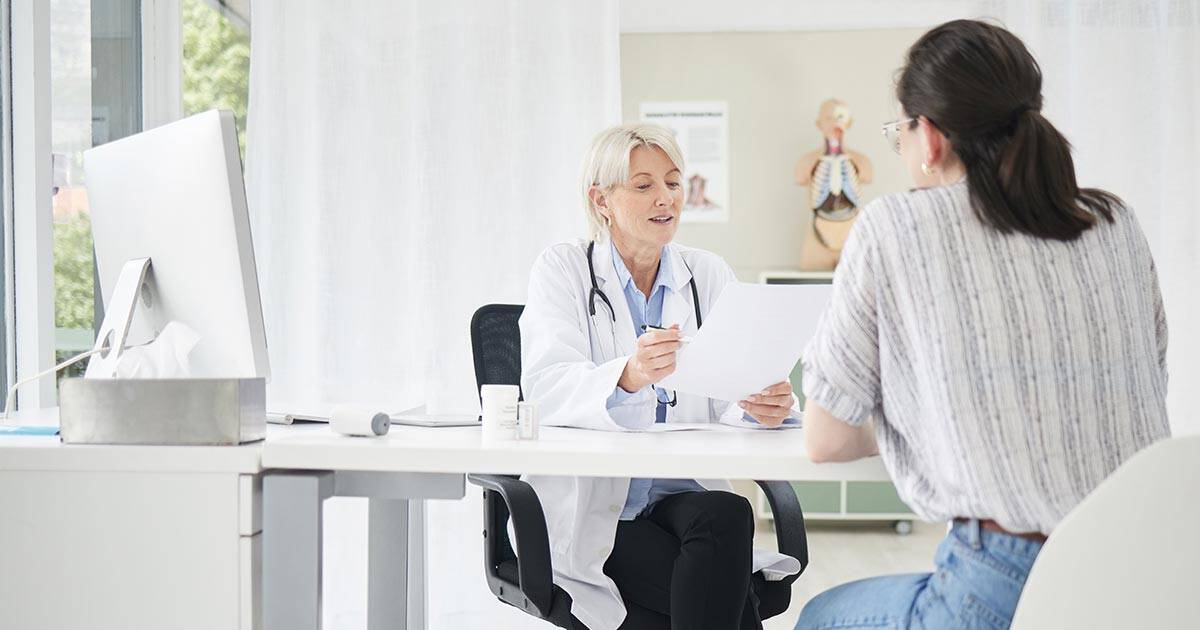 doctor consulting woman in her office
