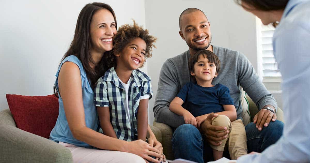 Mental Health and Living with Food Allergies 10 Mixed race family of four sitting with a food allergy counselor on how to handle the mental stress of food allergies.