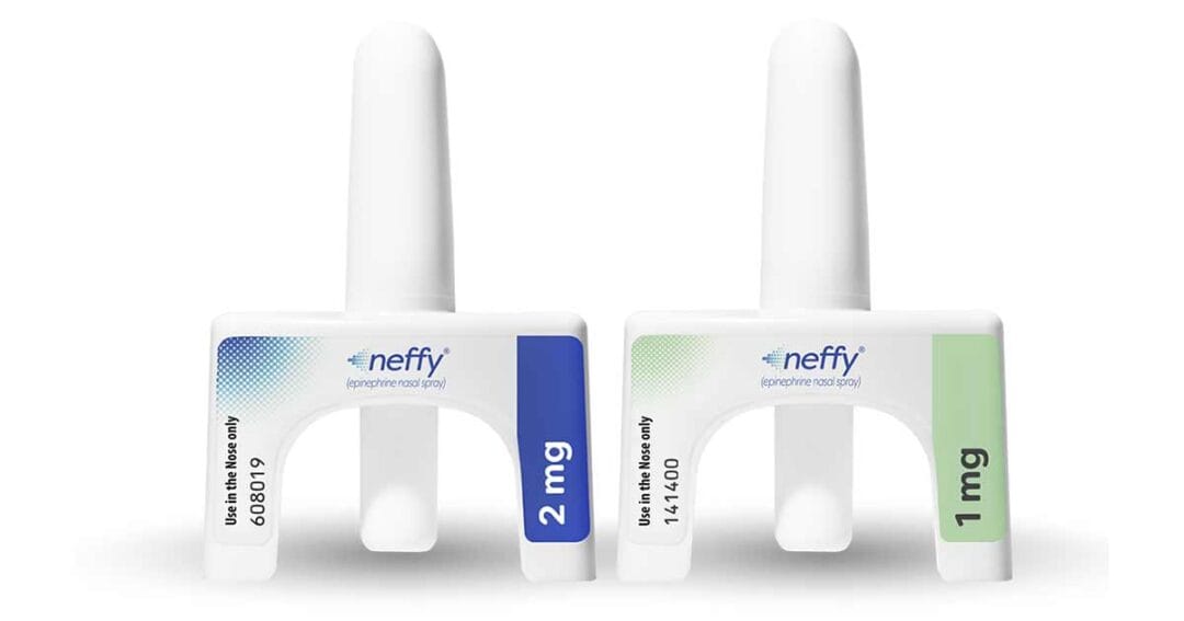 Two neffy epinephrine nasal sprays are shown upright. The left device has a blue label with “2 mg,” and the right device has a green label with “1 mg.” Both clearly state “Use in the Nose only.”.